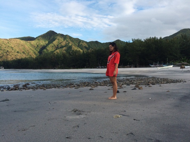 Girl standing on a shore in Talisayen Cove at Zambales.