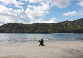 A girl looking out at the sea in Talisayen Cove, Zambales.