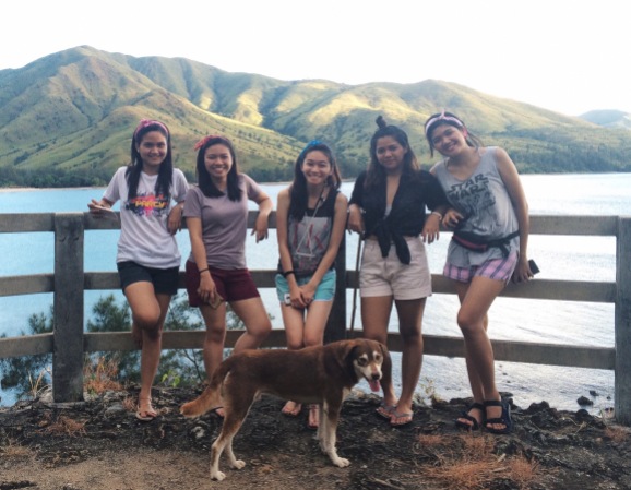 Group of friends at the view deck in Talisayen Cove at Zambales.
